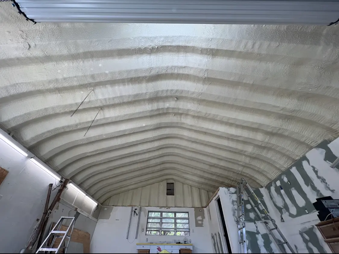 Spray polyurethane foam applied to the underside of a metal roof deck in Manhattan